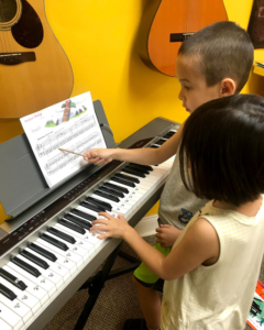 Siblings Learning Piano